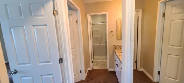 a view of hallway with window and bathroom