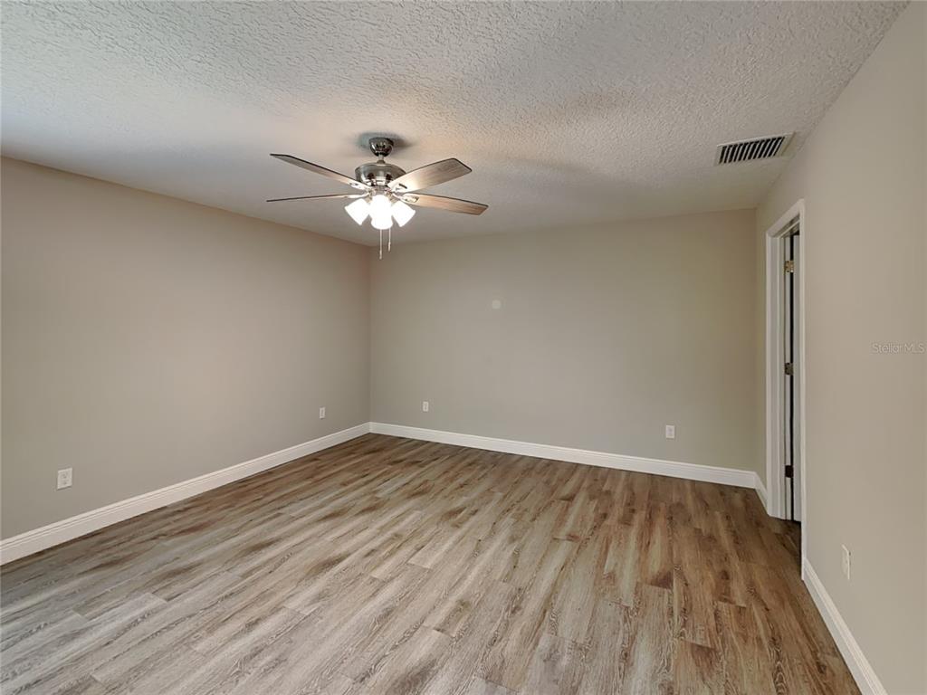 944 West Rum Place Dunnellon, FL 34434 - Photo 5 of 16 a view of an empty room with wooden floor