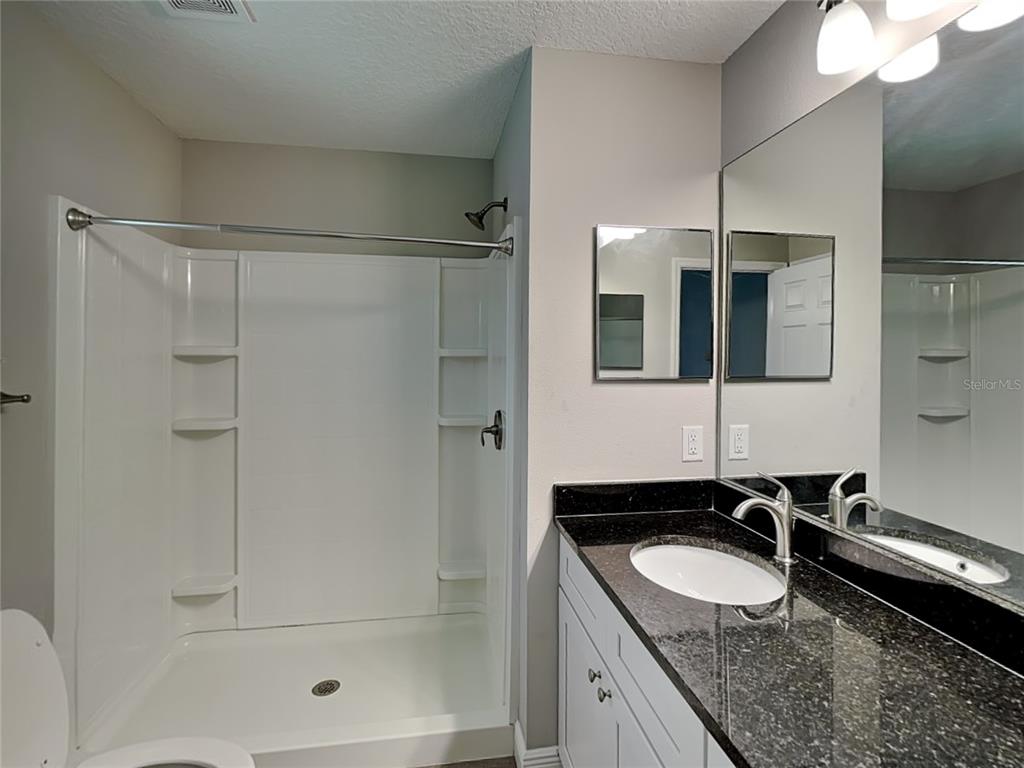 944 West Rum Place Dunnellon, FL 34434 - Photo 7 of 16 a bathroom with a granite countertop sink mirror and double