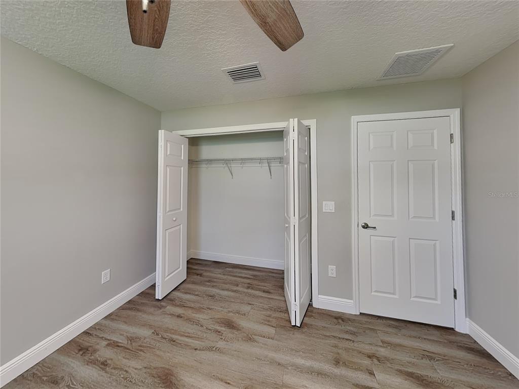 944 West Rum Place Dunnellon, FL 34434 - Photo 8 of 16 an empty room with wooden floor and closet