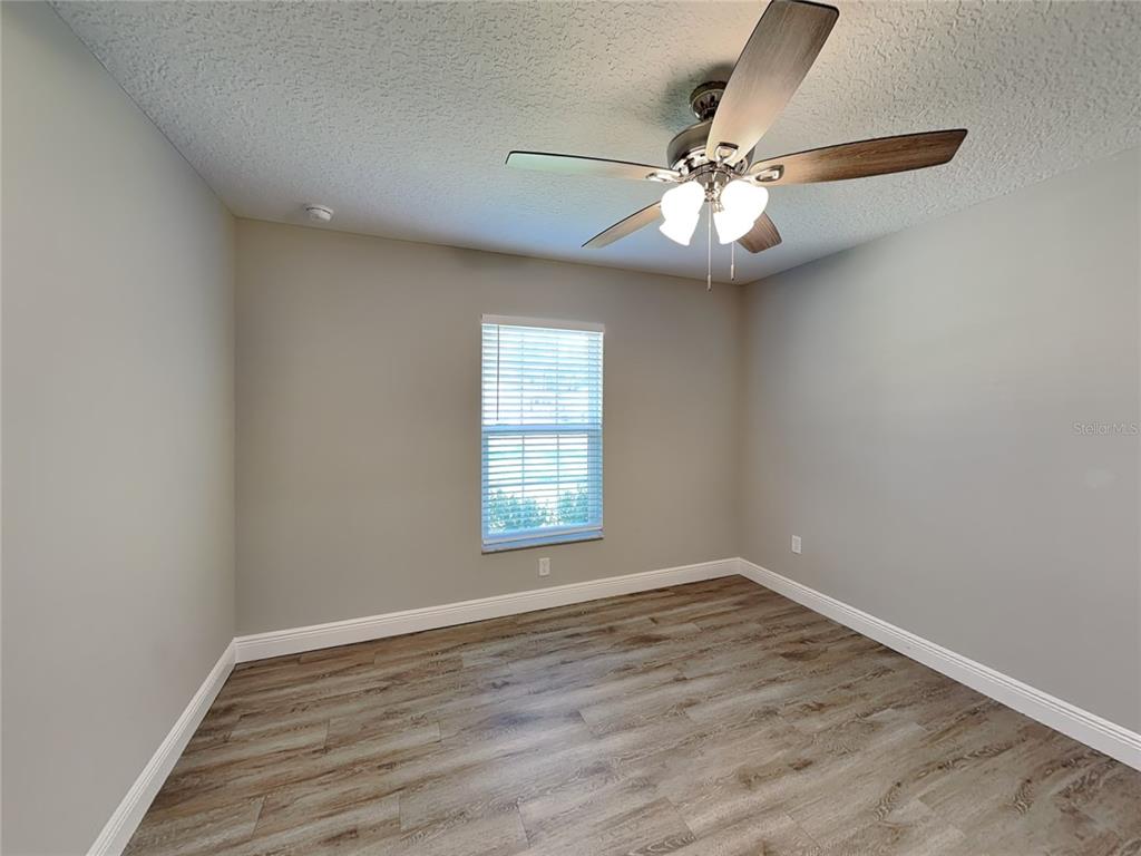 944 West Rum Place Dunnellon, FL 34434 - Photo 9 of 16 wooden floor in an empty room with a window