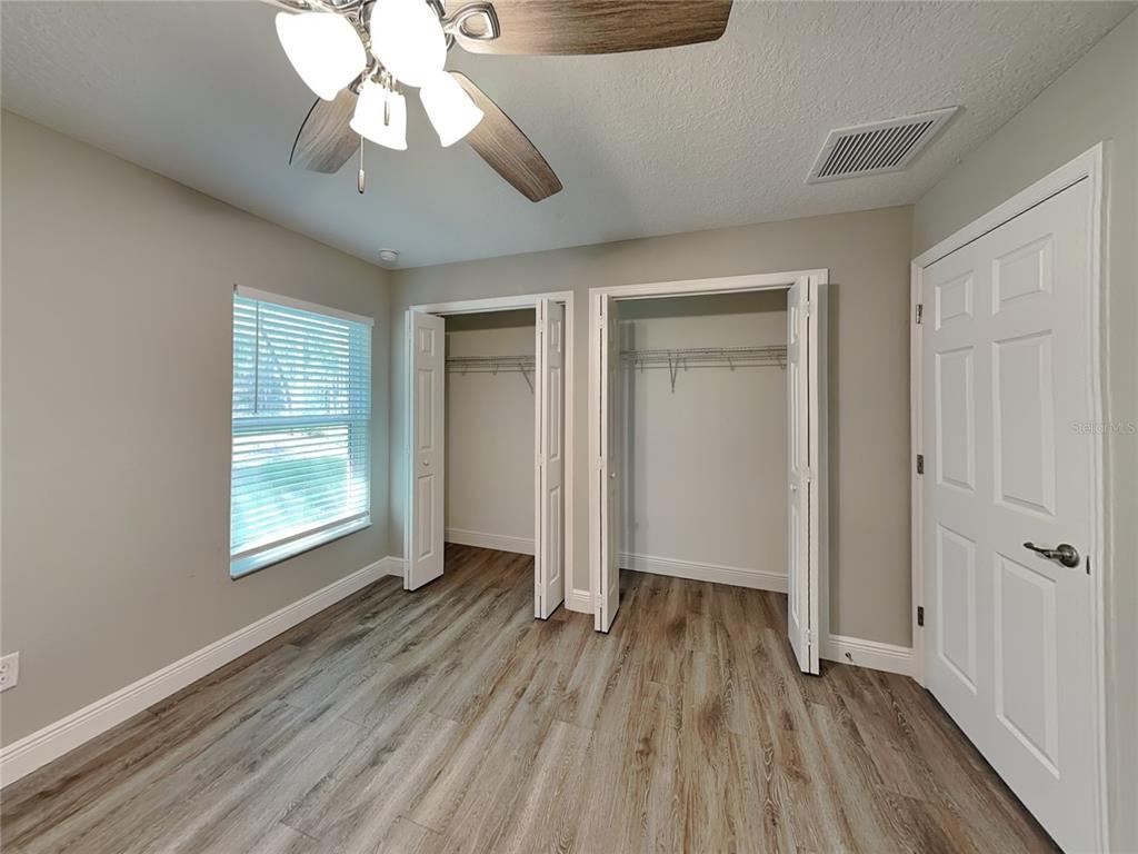 944 West Rum Place Dunnellon, FL 34434 - Photo 10 of 16 wooden floor in an empty room with a window