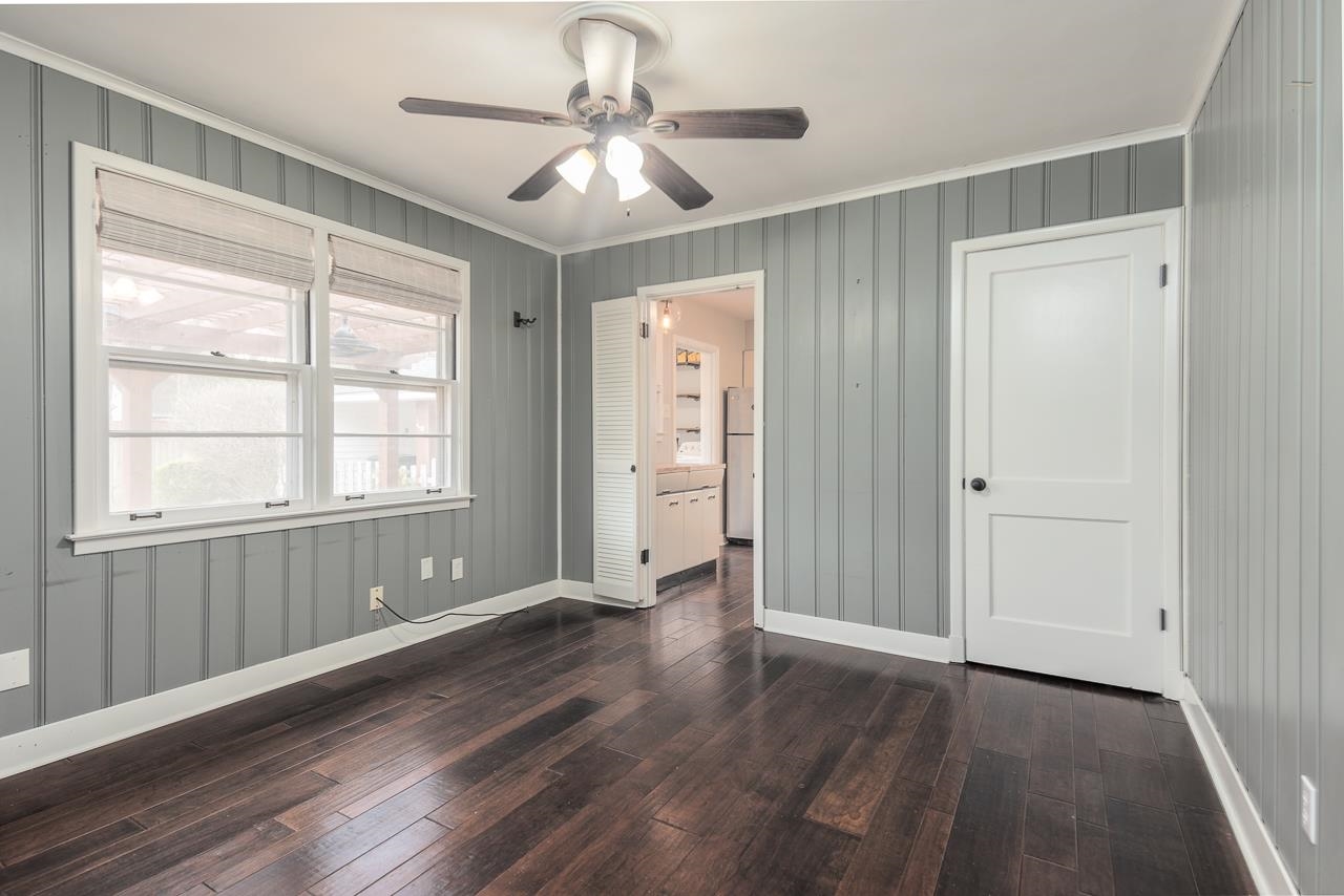 4923 Kaye Road Memphis, TN 38117 - Photo 12 of 21 a view of an empty room with wooden floor and a window