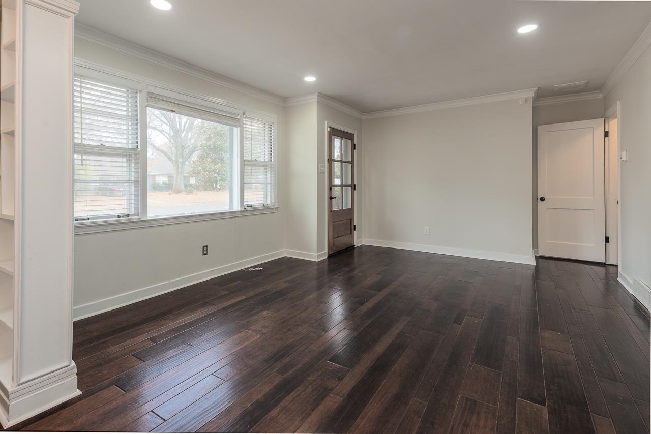 4923 Kaye Road Memphis, TN 38117 - Photo 3 of 21 an empty room with wooden floor and windows