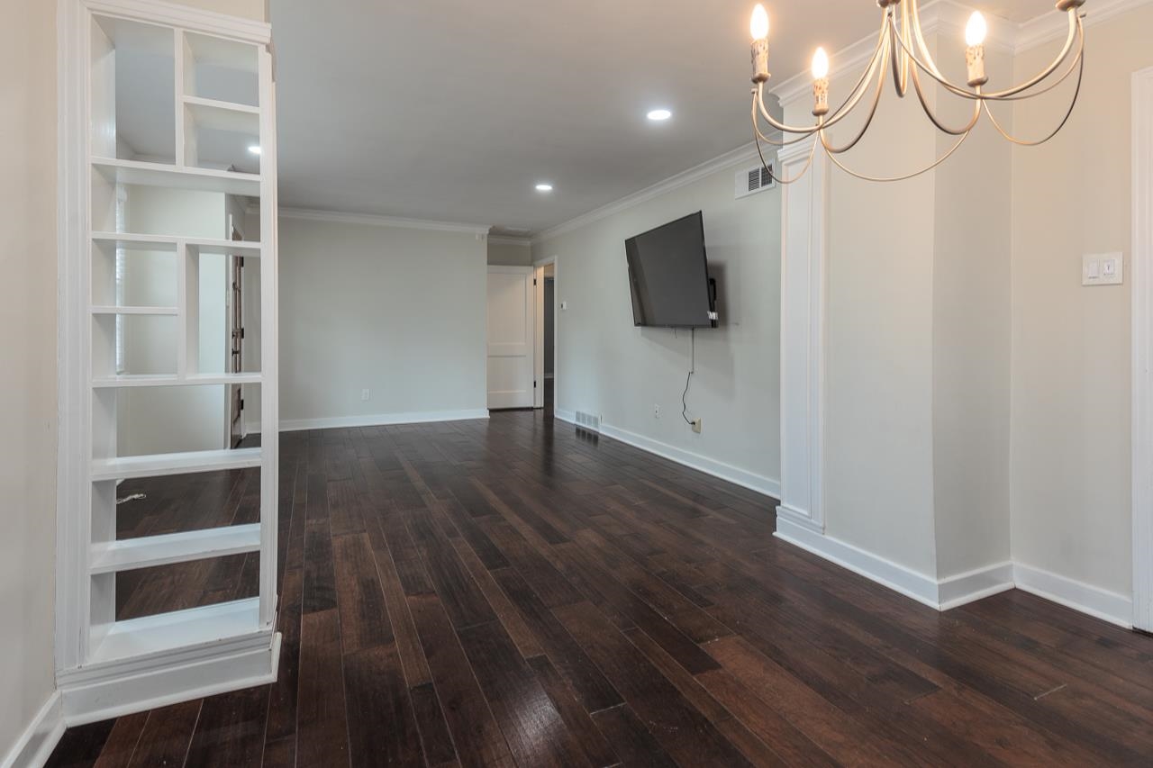 4923 Kaye Road Memphis, TN 38117 - Photo 5 of 21 a view of an empty room with wooden floor and a window