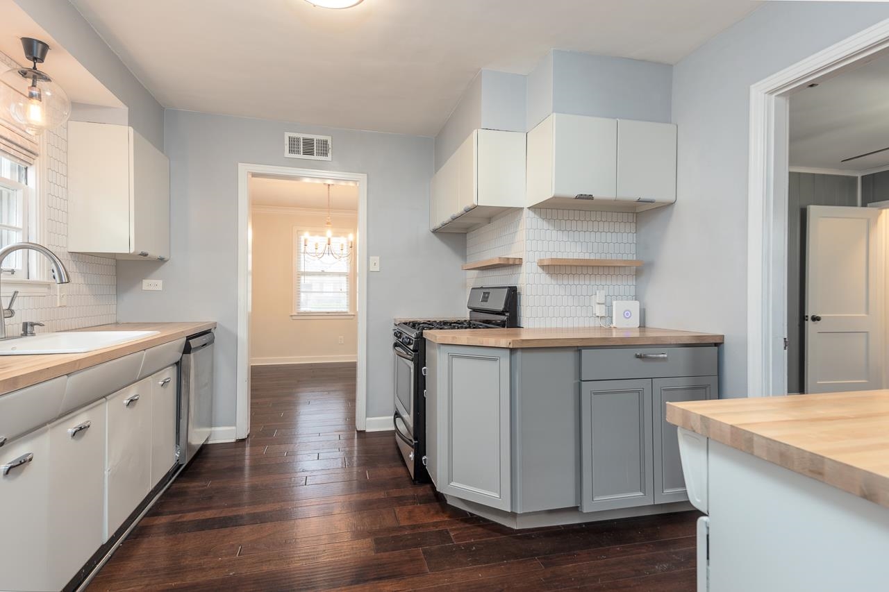 4923 Kaye Road Memphis, TN 38117 - Photo 8 of 21 a kitchen with white cabinets appliances and sink