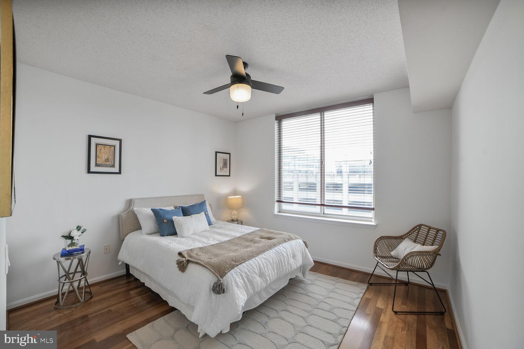 930 Wayne Avenue, Unit 708 Silver Spring, MD 20910 - Photo 17 of 35 a bedroom with a bed and wooden floor