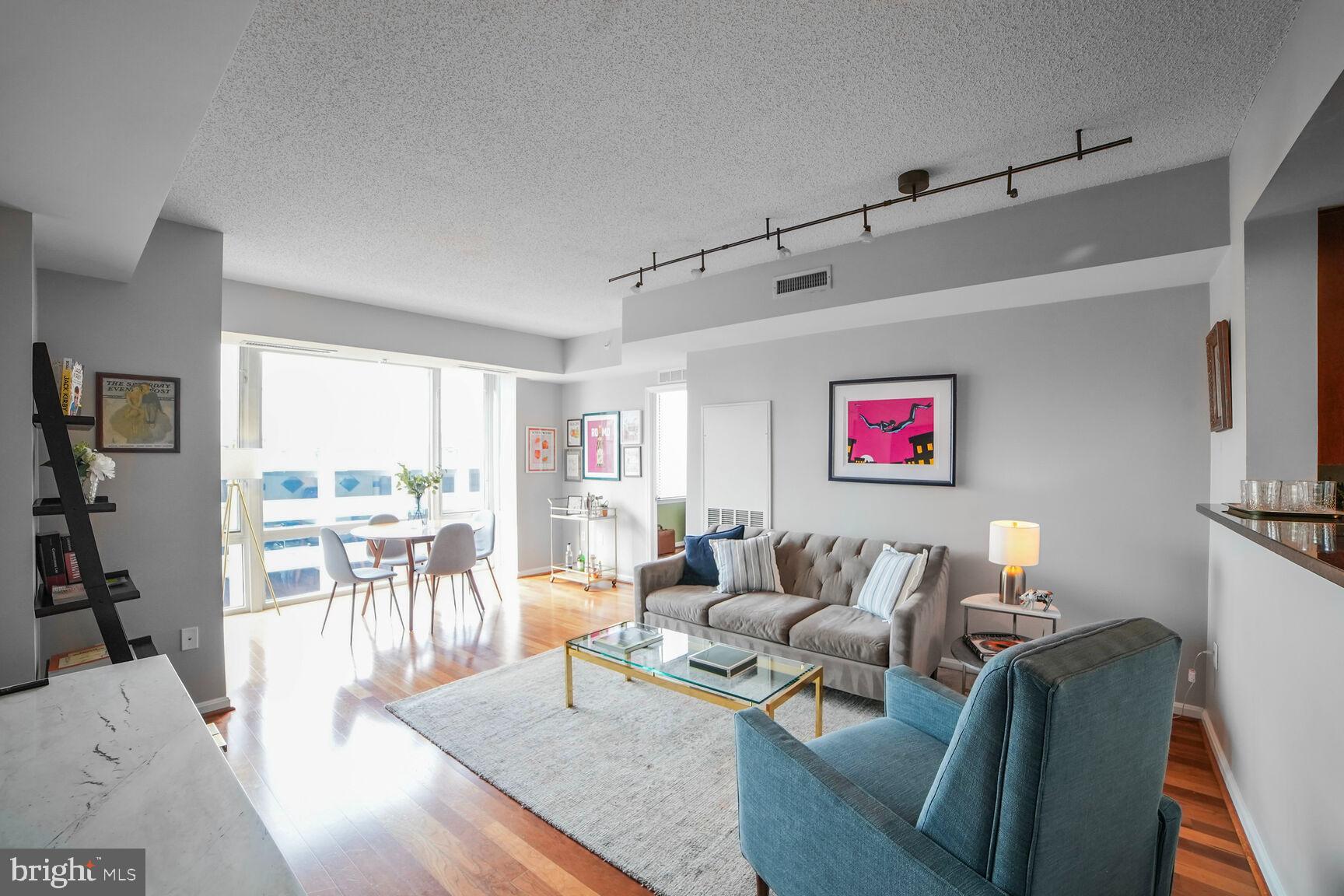 930 Wayne Avenue, Unit 708 Silver Spring, MD 20910 - Photo 8 of 35 a living room with furniture wooden floor and a large window