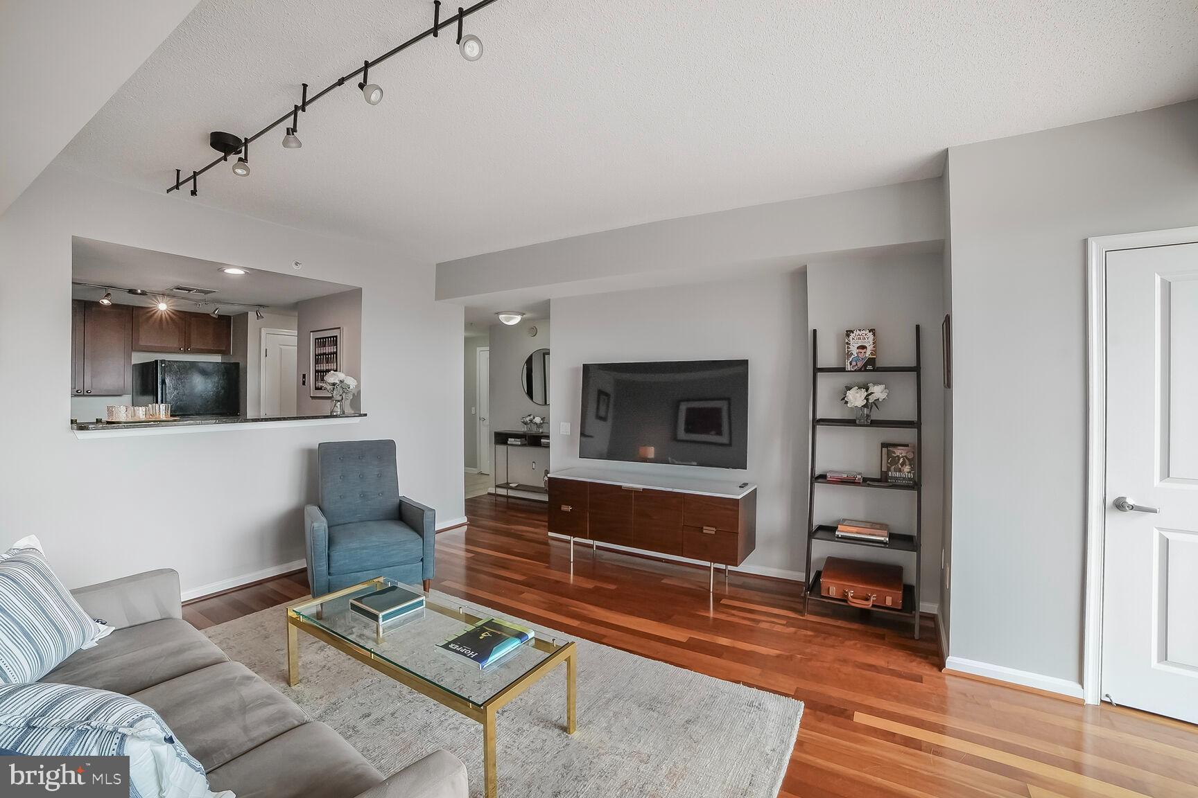 930 Wayne Avenue, Unit 708 Silver Spring, MD 20910 - Photo 10 of 35 a living room with furniture and a flat screen tv
