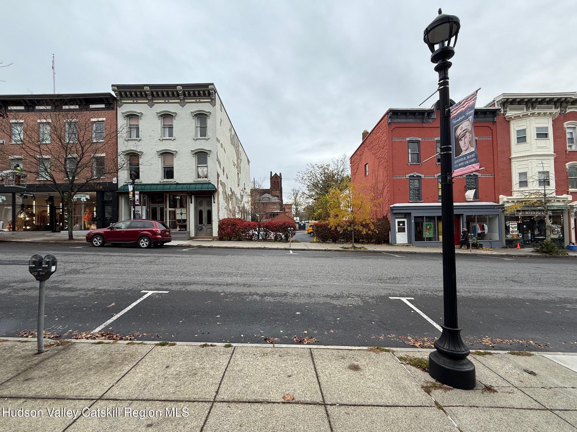 a city street lined with buildings and cars