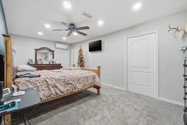 a bedroom with a large bed and a tv