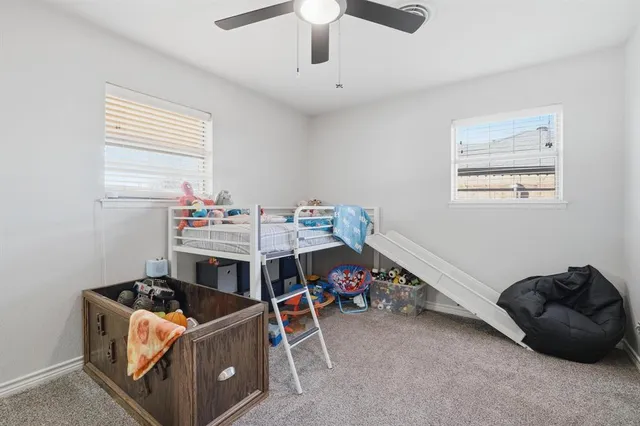 a living room with a baby bed furniture and a window