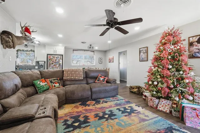 a living room with furniture and a potted plant