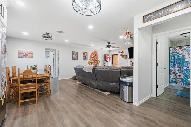 a living room with furniture and wooden floor