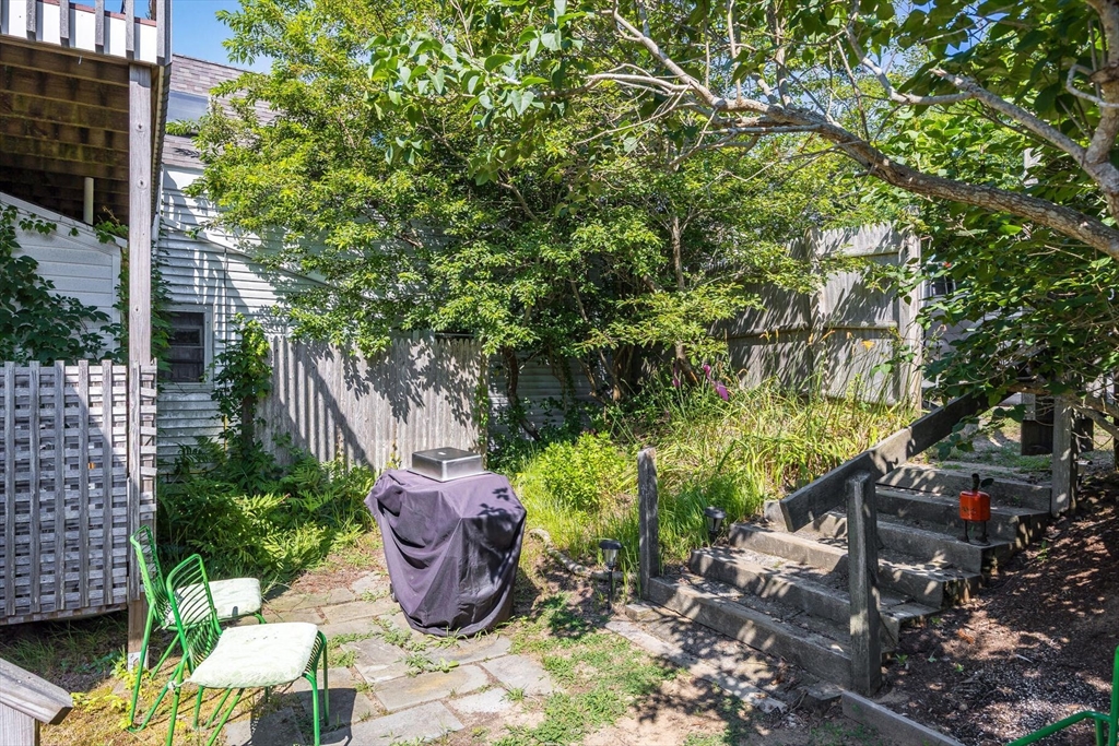 4 South Highland Road, Unit C Truro, MA 02666 - Photo 19 of 21 a view of a garden with potted plants and large trees