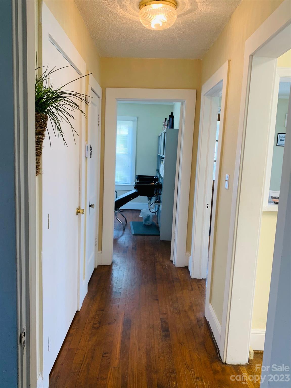 624 Main Street Hudson, NC 28638 - Photo 11 of 17 a view of a hallway with wooden floor and closet