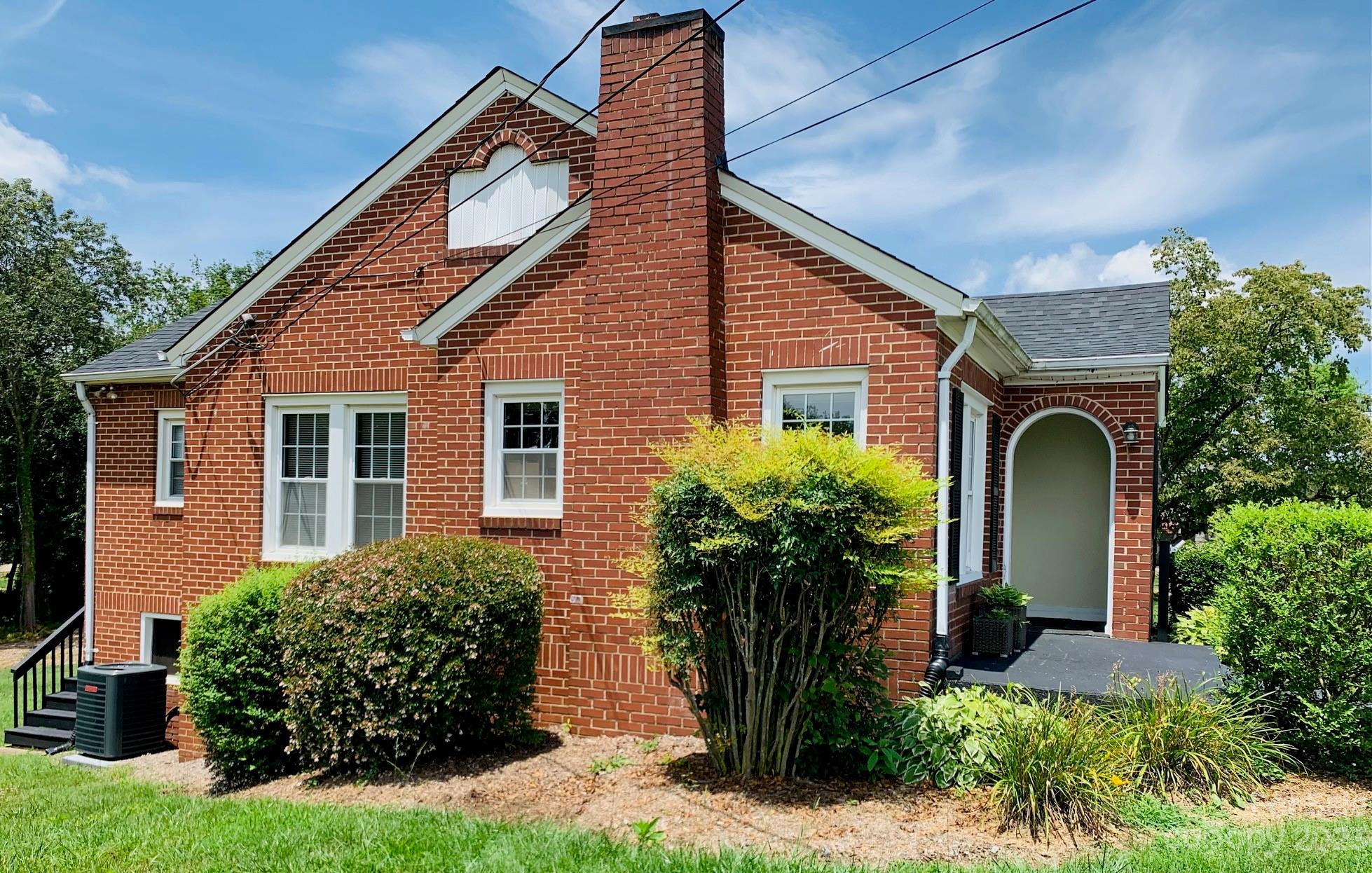 624 Main Street Hudson, NC 28638 - Photo 3 of 17 a front view of a house with a garden
