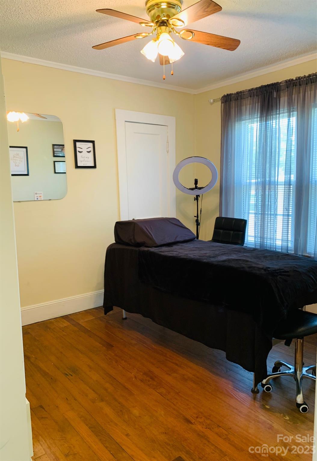 624 Main Street Hudson, NC 28638 - Photo 9 of 17 a bedroom with a bed and a chandelier
