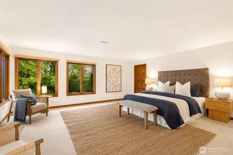 a spacious bedroom with a large bed and a large window