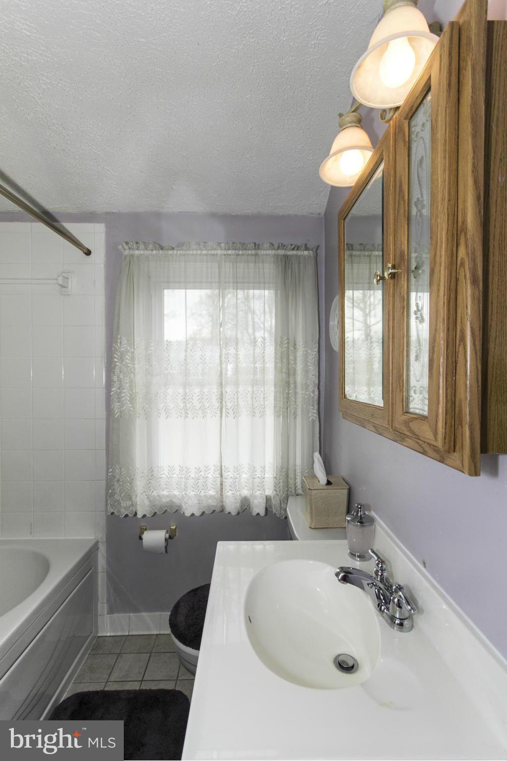 1807 Trenleigh Road Baltimore, MD 21234 - Photo 15 of 29 TILED Hall bath with oaking tub
