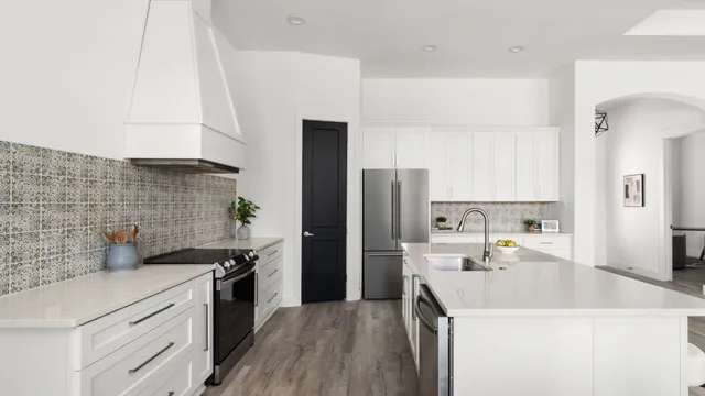 a kitchen with a sink cabinets and stainless steel appliances