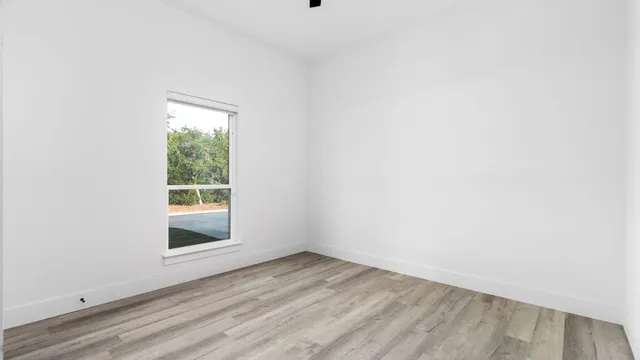 a view of walk in closet with wooden floor and floor to ceiling window