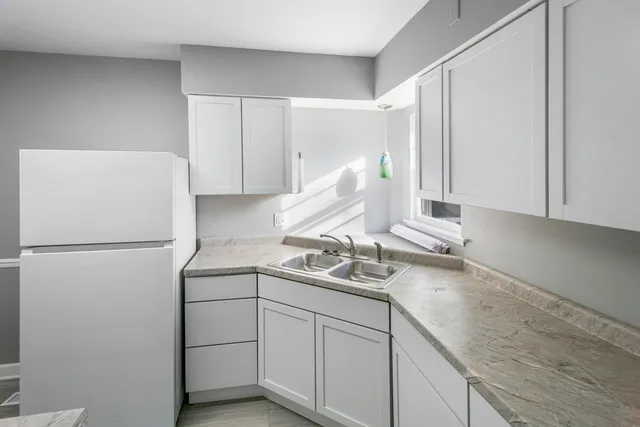 a kitchen with a sink and a refrigerator