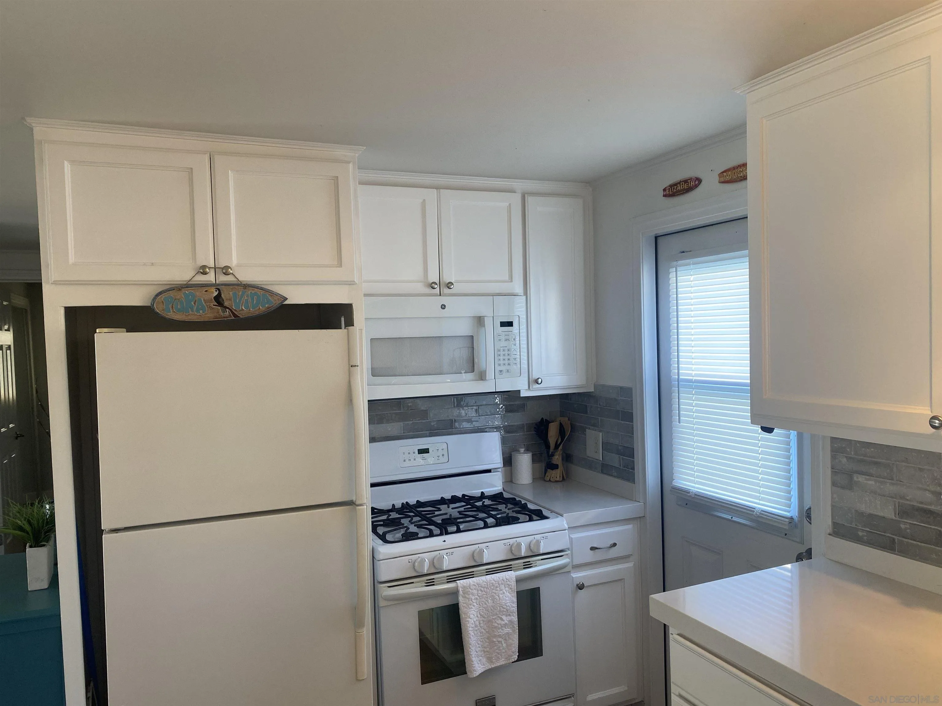 900 North Cleveland Street, Unit 33 Oceanside, CA 92054 - Photo 11 of 23 a kitchen with a stove a refrigerator and a sink