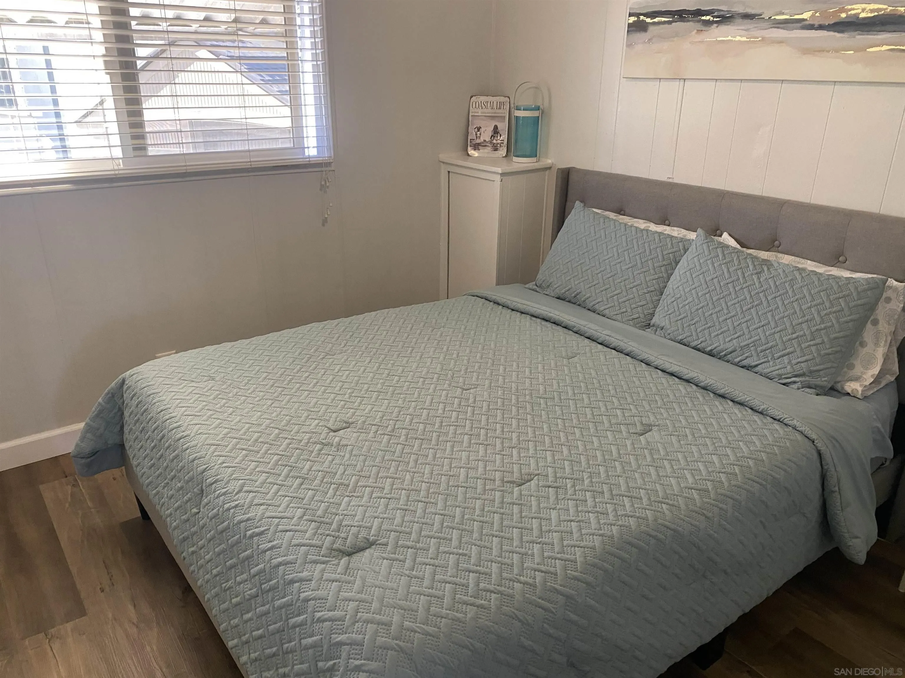 900 North Cleveland Street, Unit 33 Oceanside, CA 92054 - Photo 12 of 23 a bed sitting in a bedroom next to a window