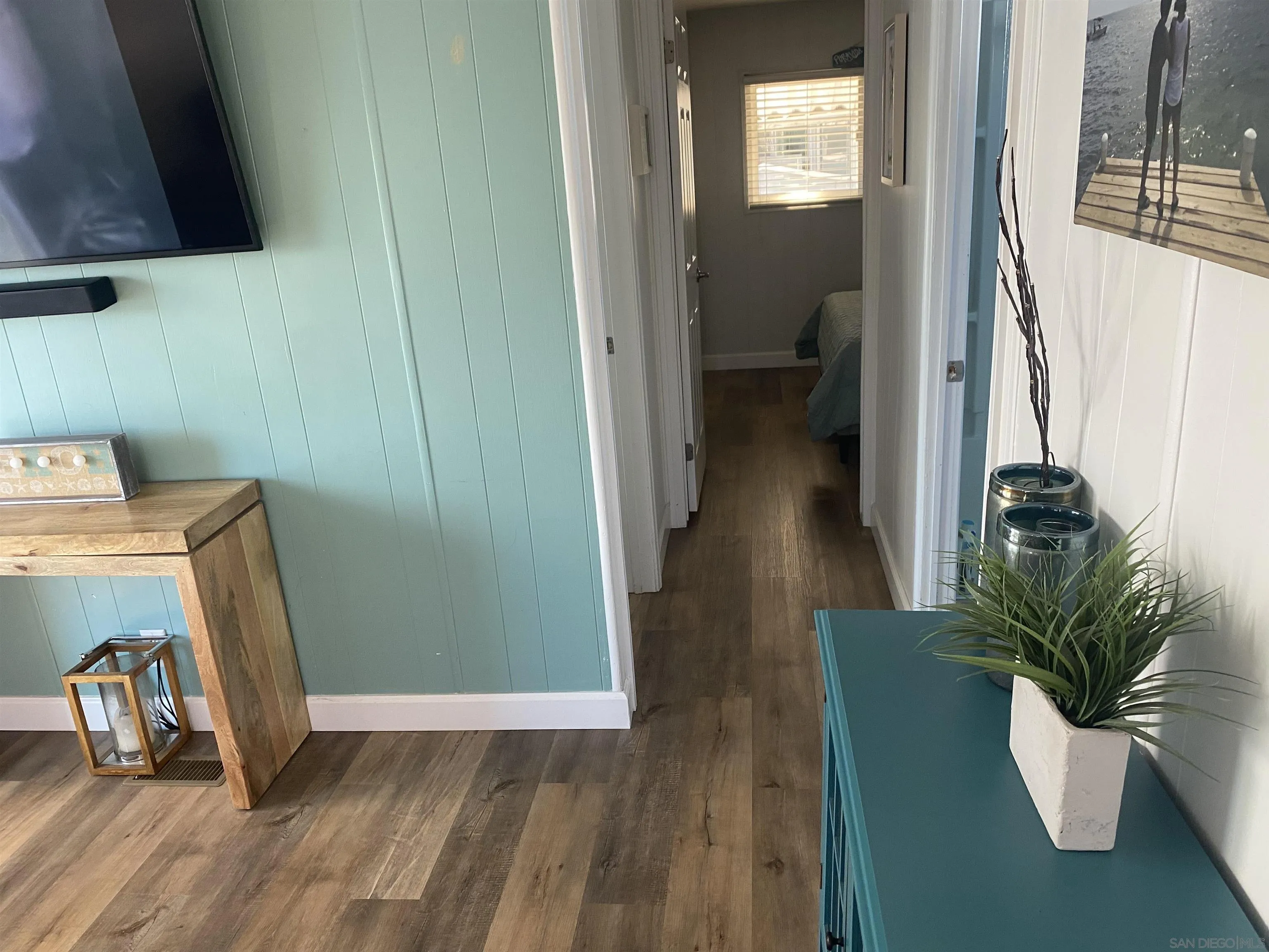 900 North Cleveland Street, Unit 33 Oceanside, CA 92054 - Photo 8 of 23 a view of a hallway with wooden floor and a potted plant