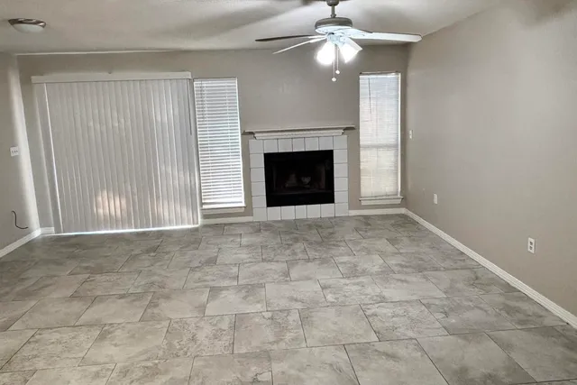 a view of an empty room with a fireplace