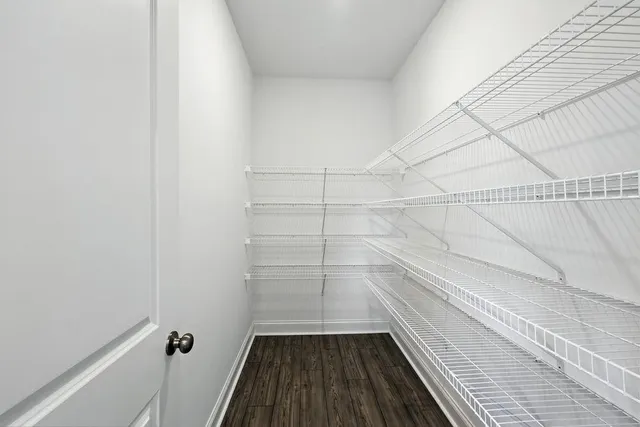 a view of a room with wooden floor and white walls