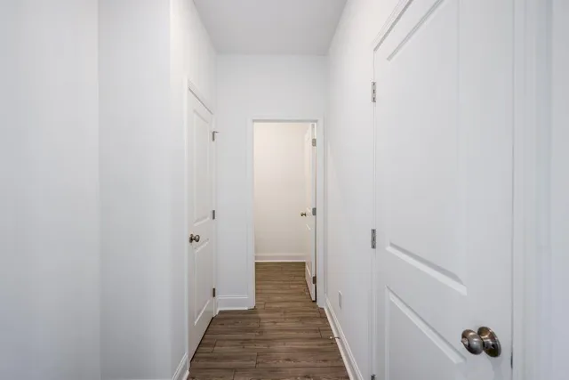 a view of a hallway with wooden floor