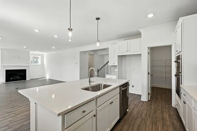 a kitchen with sink cabinets and wooden floor