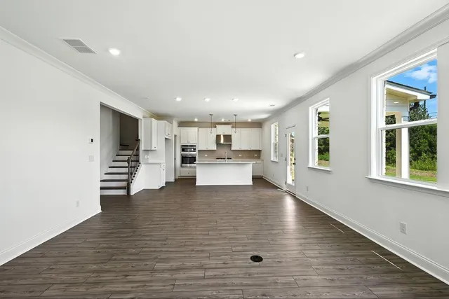a view of kitchen with furniture and wooden floor