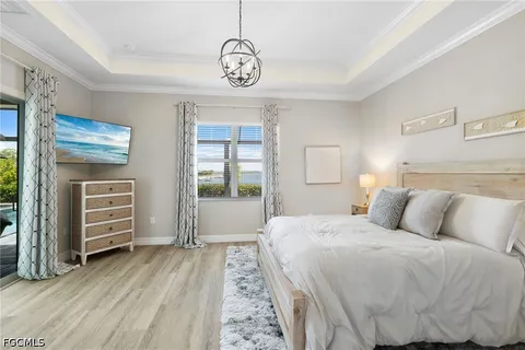 a bedroom with a bed and a chandelier