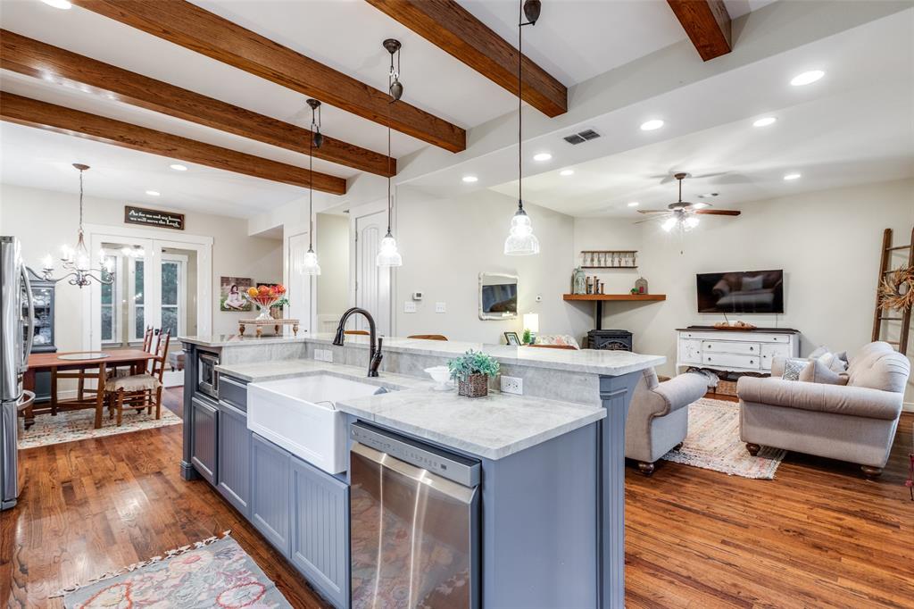 322 Red Maple Road Gunter, TX 75058 - Photo 12 of 33 a large white kitchen with a large island in the center