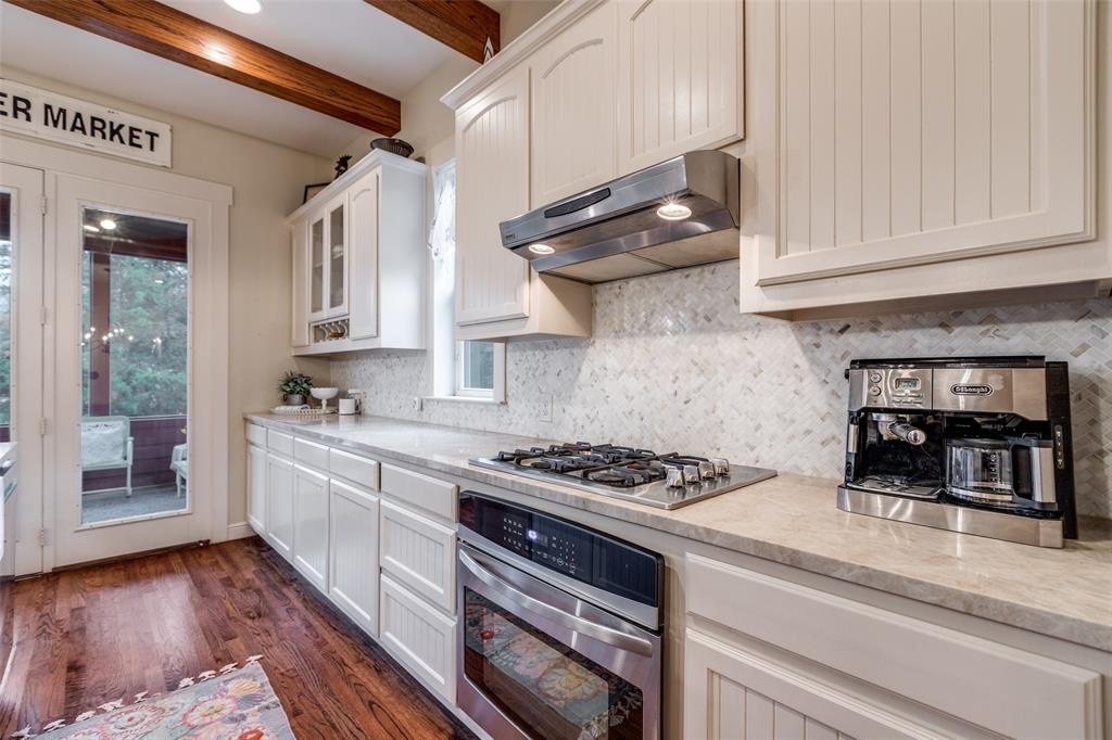 322 Red Maple Road Gunter, TX 75058 - Photo 14 of 33 a kitchen with stainless steel appliances granite countertop a stove and a white cabinets