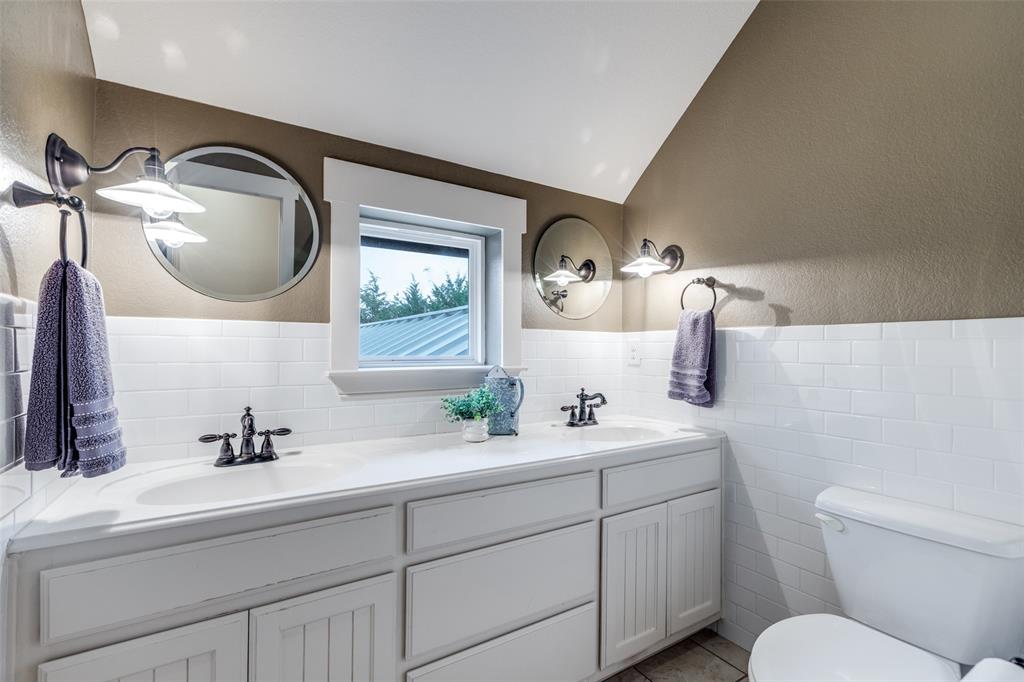 322 Red Maple Road Gunter, TX 75058 - Photo 24 of 33 a bathroom with a toilet sink and mirror