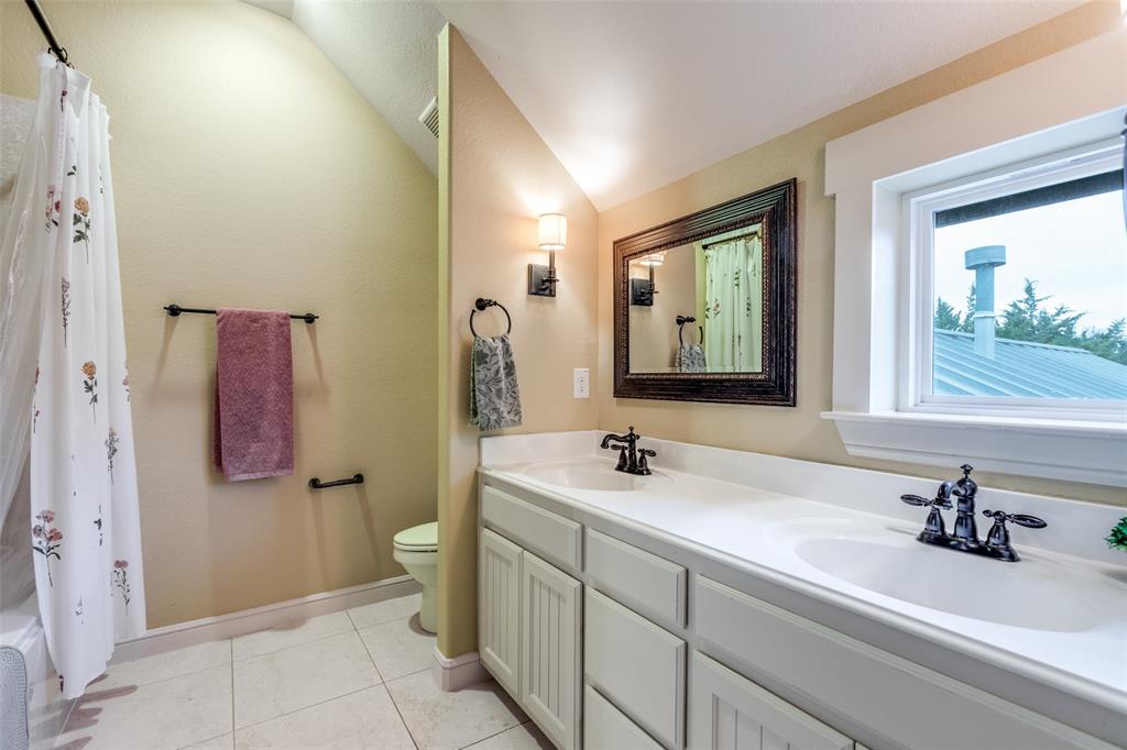 322 Red Maple Road Gunter, TX 75058 - Photo 29 of 33 a bathroom with a sink and a mirror