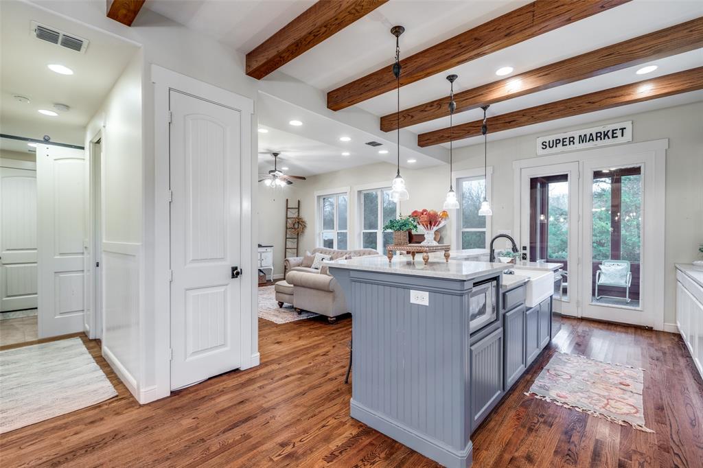 322 Red Maple Road Gunter, TX 75058 - Photo 7 of 33 a large kitchen with stainless steel appliances kitchen island granite countertop a large counter top and sink