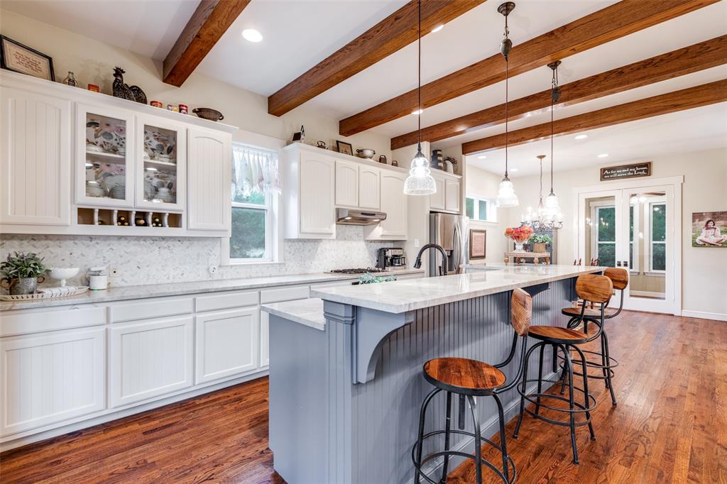 322 Red Maple Road Gunter, TX 75058 - Photo 9 of 33 a kitchen with stainless steel appliances granite countertop a stove and cabinets