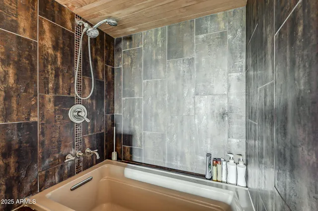 a bathroom with a tub and shower