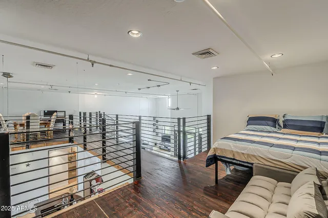 a view of a room with lots of wooden furniture and a chandelier