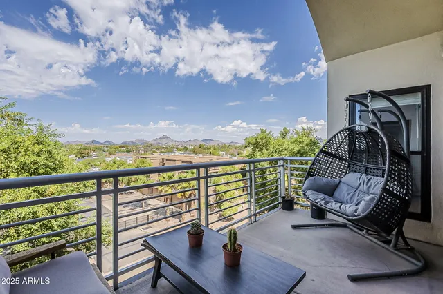 a view of a balcony with furniture