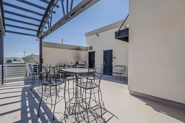 a dining room with furniture and a kitchen view