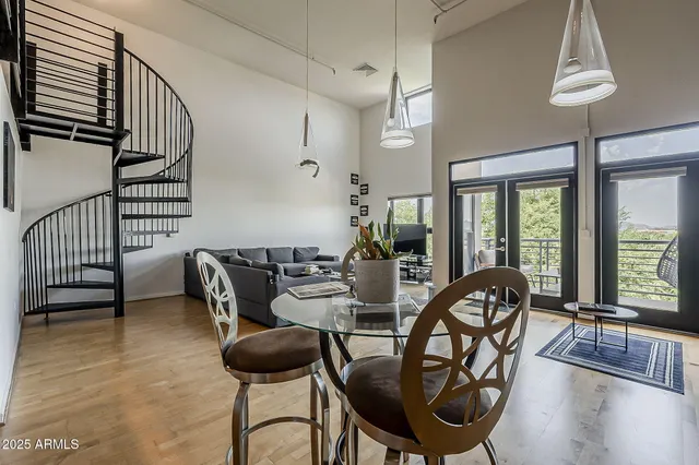 a view of a livingroom and dining room with furniture wooden floor and a chandelier