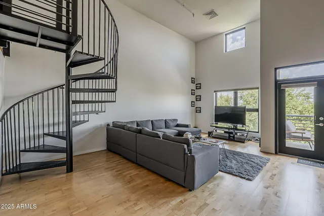 a living room with furniture wooden floor and a flat screen tv