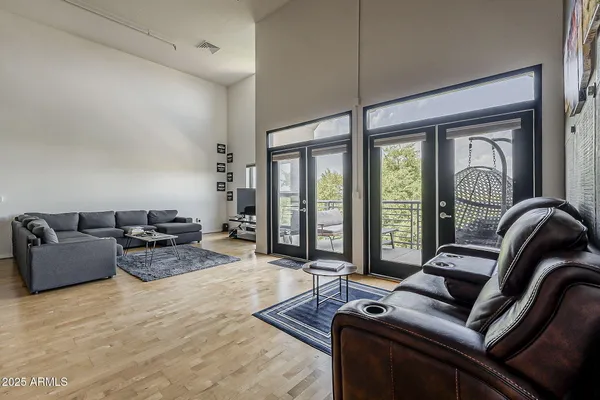 a living room with furniture and floor to ceiling windows