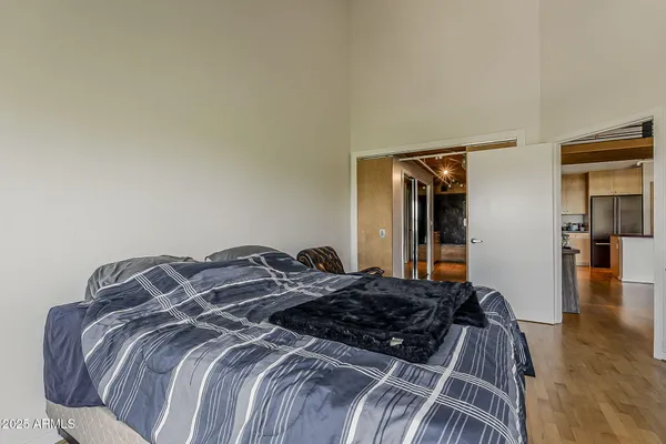 a bedroom with a bed and wooden floor